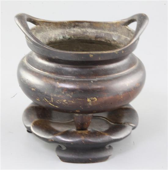 A Chinese bronze ding censer and stand, width 15.5cm